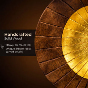 The image is a close-up of a wooden object with a gold-colored circular element, showcasing the craftsmanship and the unique carved details.