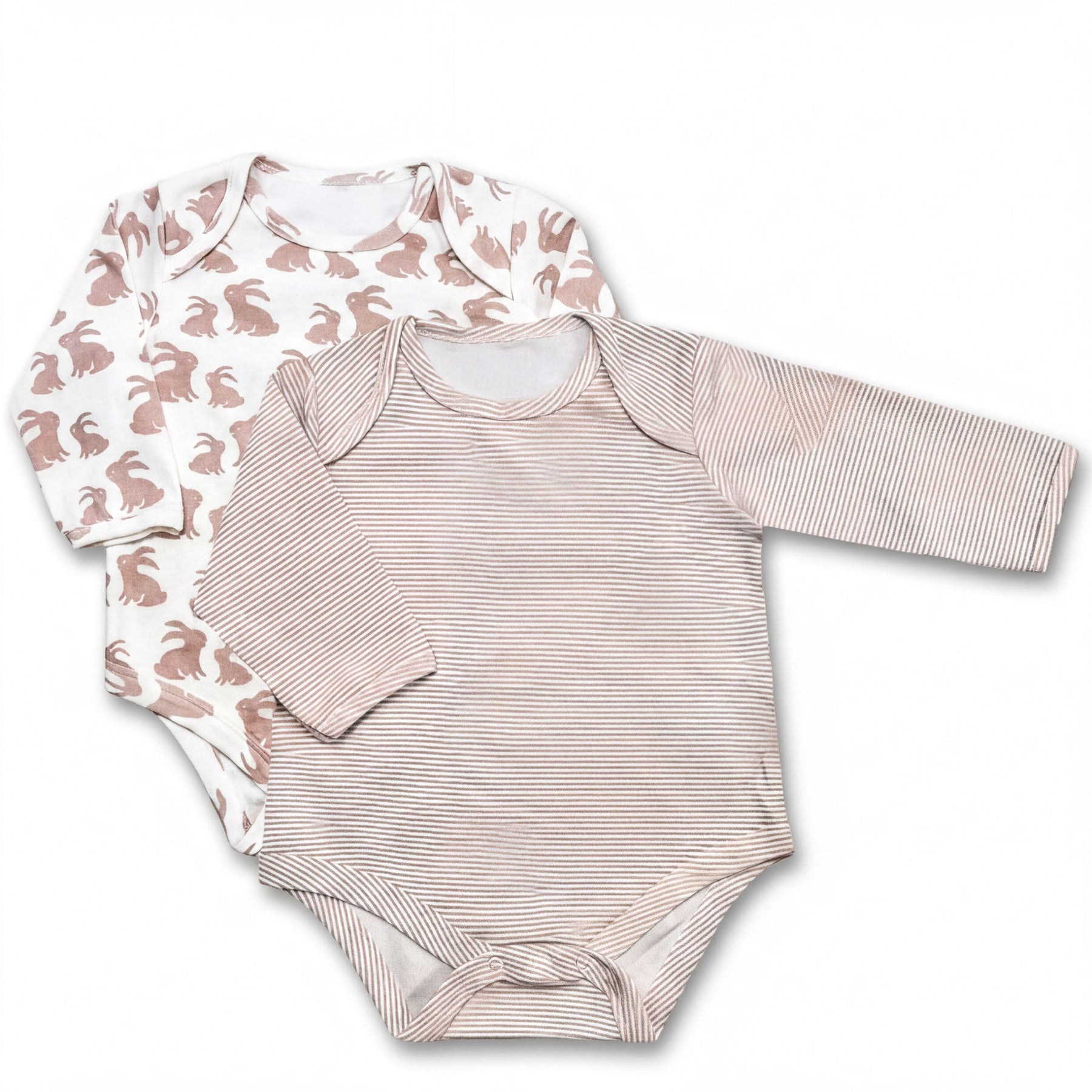 two baby onesies, one with a white pattern and the other with a striped pattern, both featuring long sleeves.