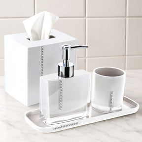 Set of four crystal white bathroom accessories including soap dish, toothbrush holder, tumbler, and soap dispenser.