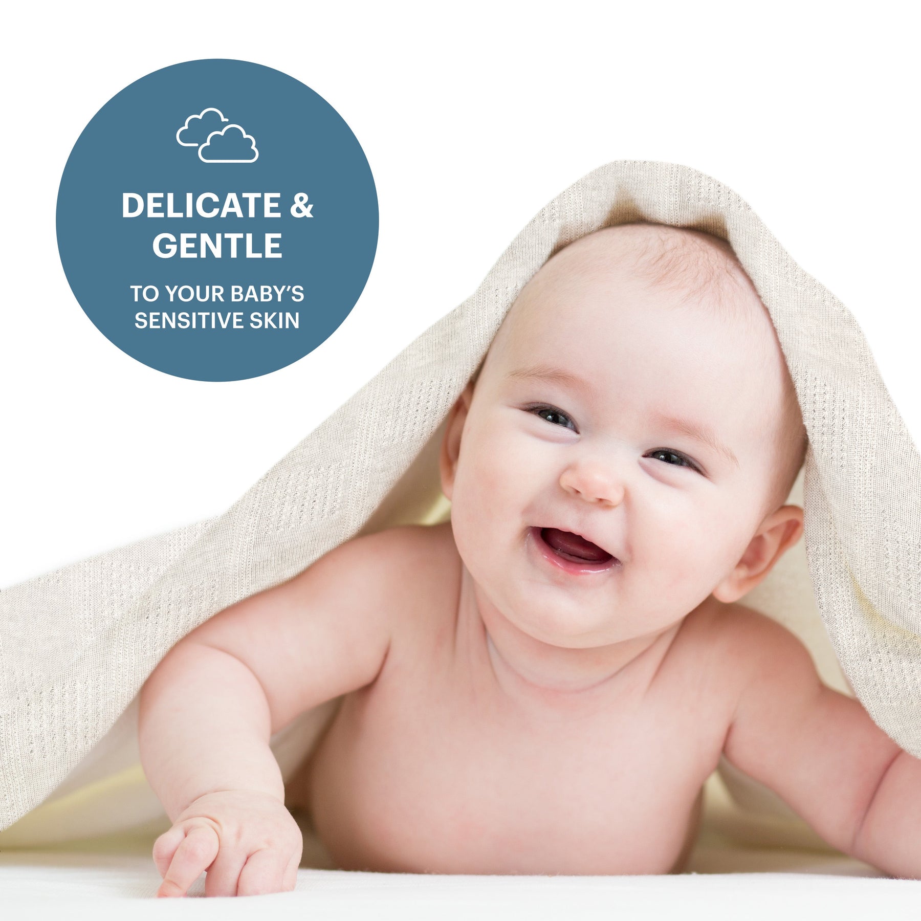 A smiling baby is peeking out from under a beige blanket, with a blue circle containing the text "Delicate & Gentle TO YOUR BABY'S SENSITIVE SKIN" above the image.