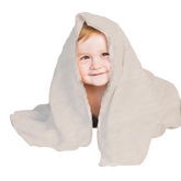 A young child with a smile on their face is partially hidden behind a white, patterned blanket.