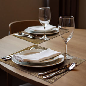 Set of 6 gold PVC cut-out placemats with intricate designs, ideal for protecting tables and enhancing dining decor.