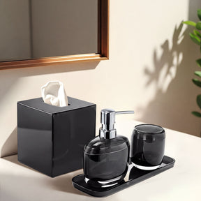 Set of four modern bathroom décor accessories from The Aurik Collection, featuring sleek and elegant design in a stylish bath set.