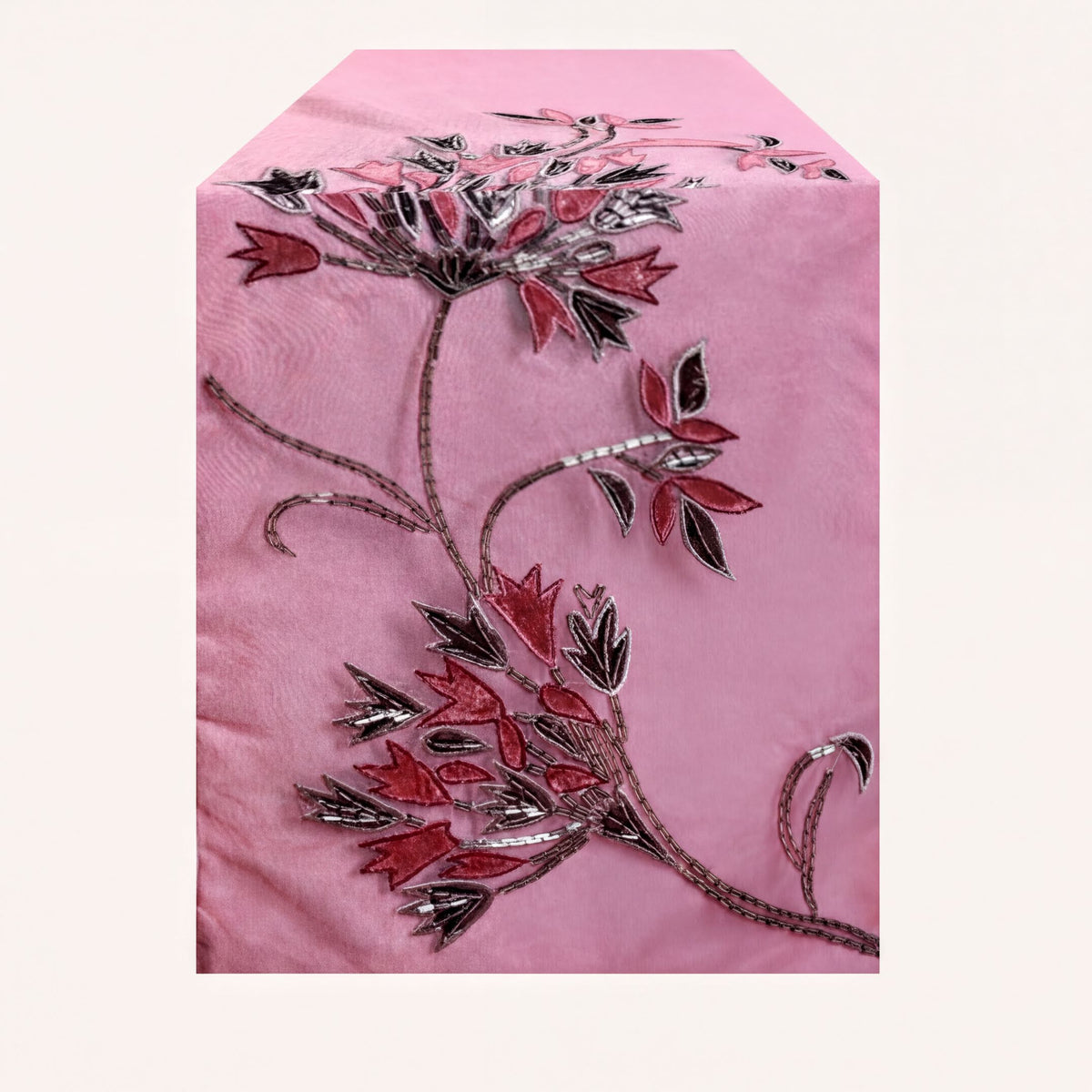 Embroidered decorative table runner with intricate floral patterns, perfect for enhancing dining or event tables.