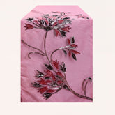 Embroidered decorative table runner with intricate floral patterns, perfect for enhancing dining or event tables.