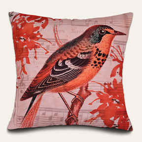 A decorative throw pillow with a vibrant illustration of a colorful bird perched on a branch, surrounded by musical notes and flowers.