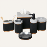 A set of black and white bathroom accessories, including a tissue box, soap dispenser, toothbrush holder, and other small containers.