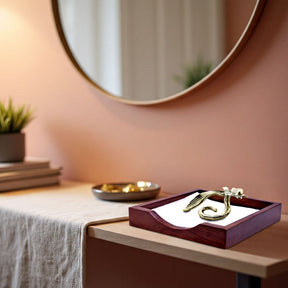 Solid wood napkin holder with silver and gold finish ornament, stylish countertop accessory for napkin organization.