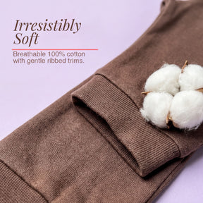 a pair of brown cotton socks with a single white cotton fiber on top, accompanied by text that describes the socks as "Irresistibly Soft" and "Breathable 100% cotton with gentle ribbed trims."