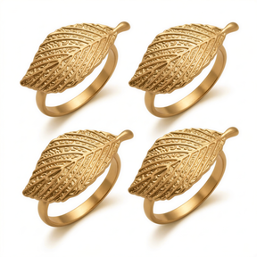 four gold-colored rings with leaf-shaped designs.
