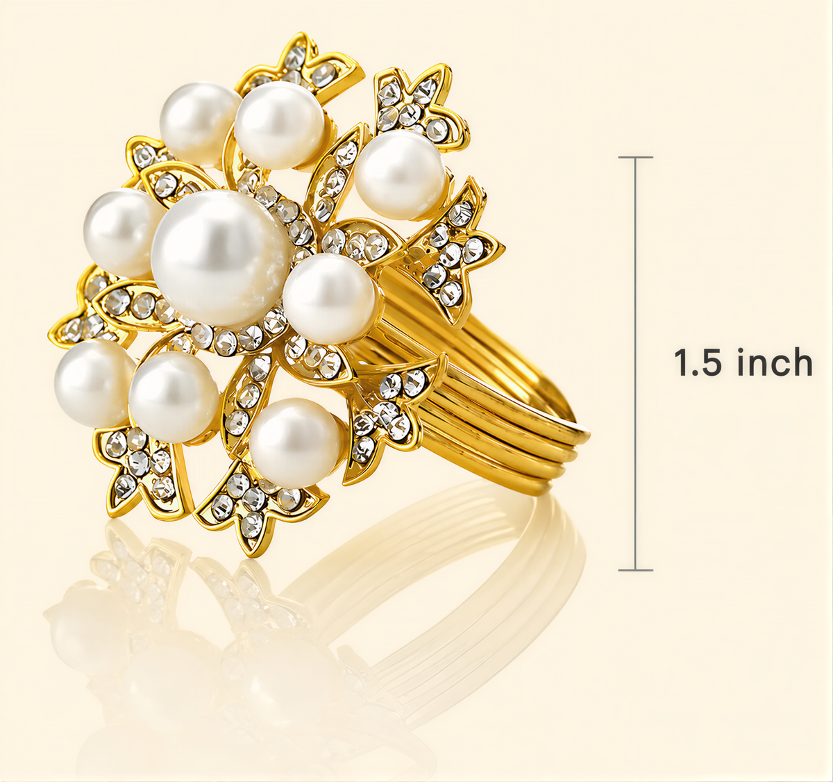A gold ring adorned with white pearls and sparkling diamonds, with a measurement scale indicating it is 1.5 inches in size.