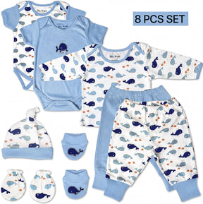 A set of baby clothing and accessories, including a blue onesie, blue pants, a blue hat, and matching blue socks, all featuring a whale pattern.
