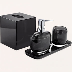 Set of four modern bathroom décor accessories from The Aurik Collection, including soap dispenser, toothbrush holder, and matching containers.