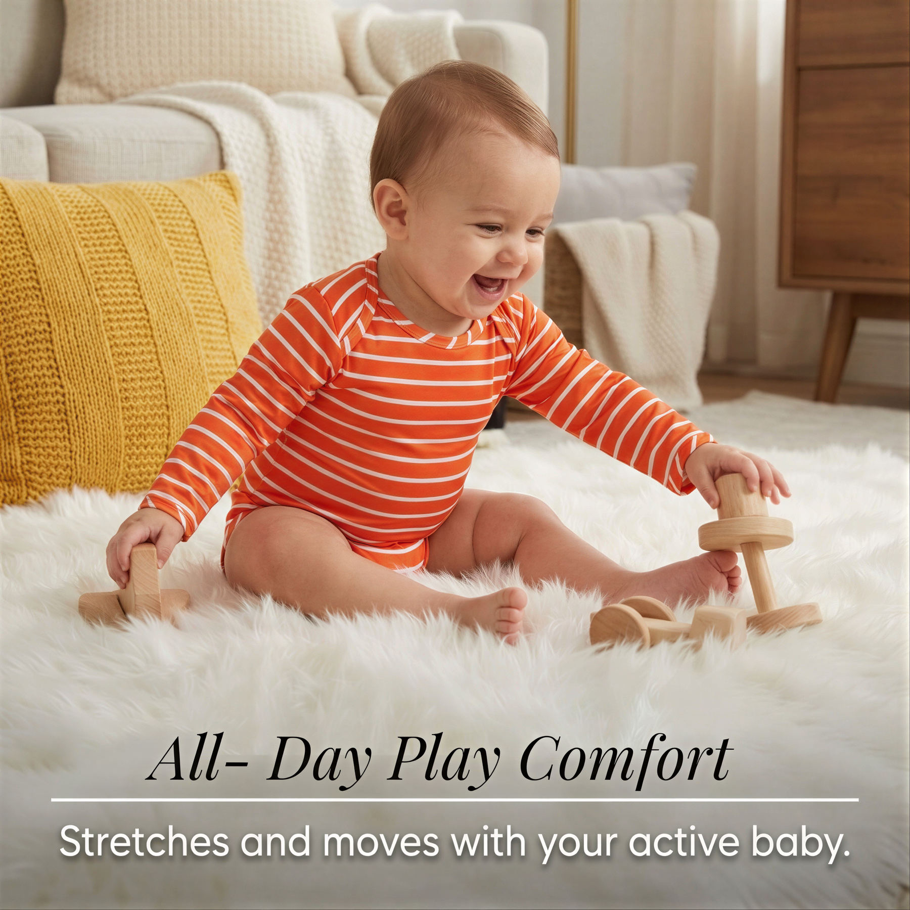 A smiling baby in an orange and white striped onesie sitting on a white rug and playing with wooden toys.