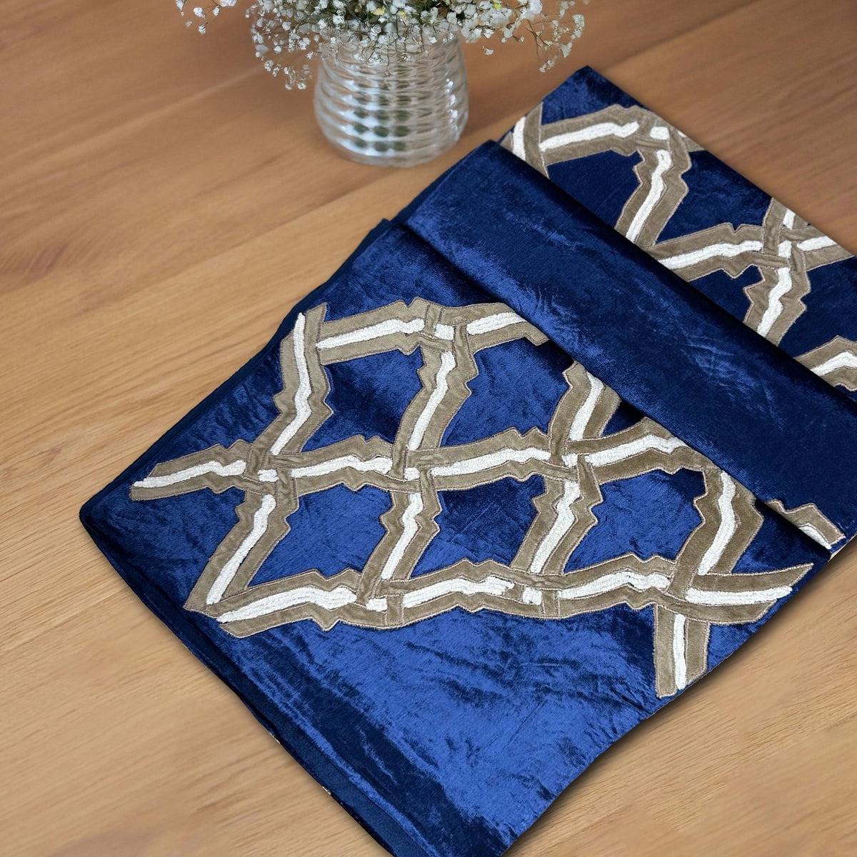 Embroidered decorative table runner with intricate patterns, designed to add elegance to dining or event tables.