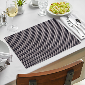 Black and gold PVC placemats with a decorative design, heat-resistant, washable, and wipeable for indoor and outdoor dining.