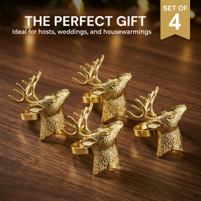 A set of four golden deer head coasters arranged on a wooden surface.