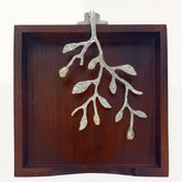 Solid wood napkin holder with silver and gold finish ornament, elegant design for stylish table settings.
