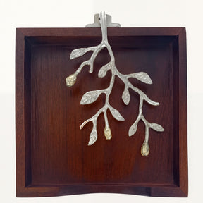 Solid wood napkin holder with silver and gold finish ornament, elegant design for stylish table settings.