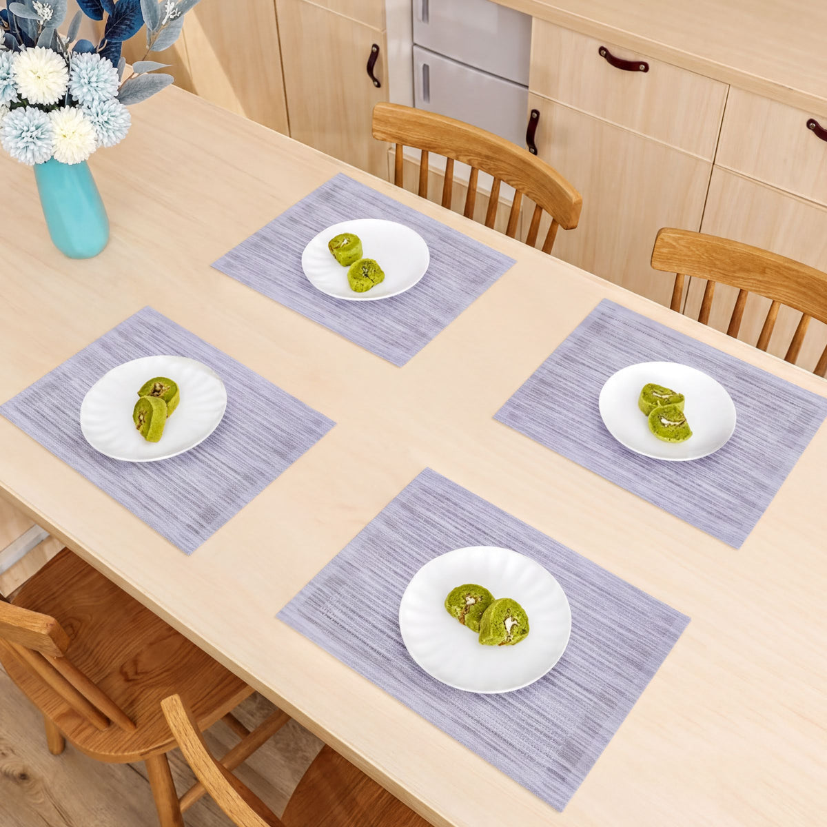 Set of four PVC placemats for dining tables, durable and easy to clean, perfect for protecting surfaces during meals.