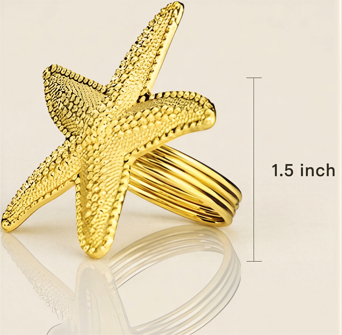 A gold starfish ring is shown against a light background, with a measurement line indicating it is 1.5 inches in size.