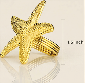 A gold starfish ring is shown against a light background, with a measurement line indicating it is 1.5 inches in size.
