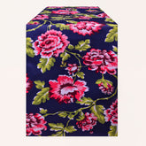 Blue printed table runner from RN-1 with intricate patterns, laid out on a table for a decorative dining setting.