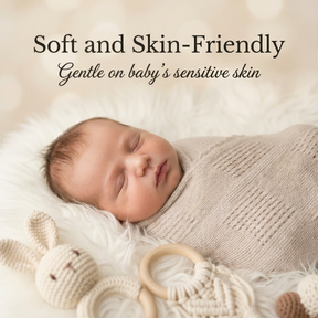 A newborn baby is peacefully sleeping, swaddled in a soft blanket, with a wooden toy rabbit nearby.