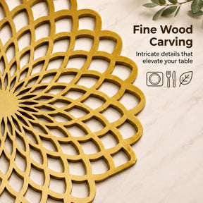 a close-up view of a decorative gold-colored wooden carving on a marble surface.
