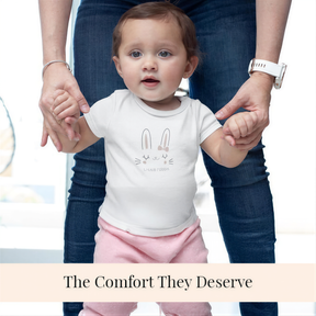 A smiling baby wearing a bunny-themed shirt is being held by an adult, with the caption "The Comfort They Deserve" below the image.