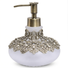 A decorative soap dispenser with a white body and a gold pump. The soap dispenser has an ornate, embellished design with a floral pattern and sparkling rhinestones or crystals.