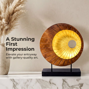 a decorative wooden sculpture with a golden circular design, placed on a marble countertop.