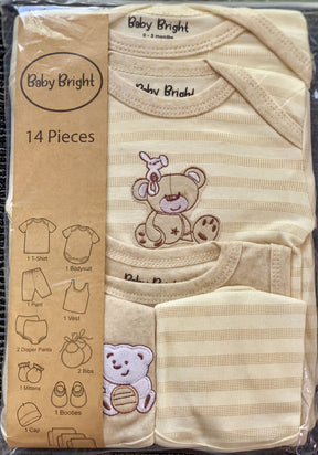 A package containing a set of baby clothing items, including a t-shirt, bodysuit, pants, and booties, with a teddy bear design on the clothing.
