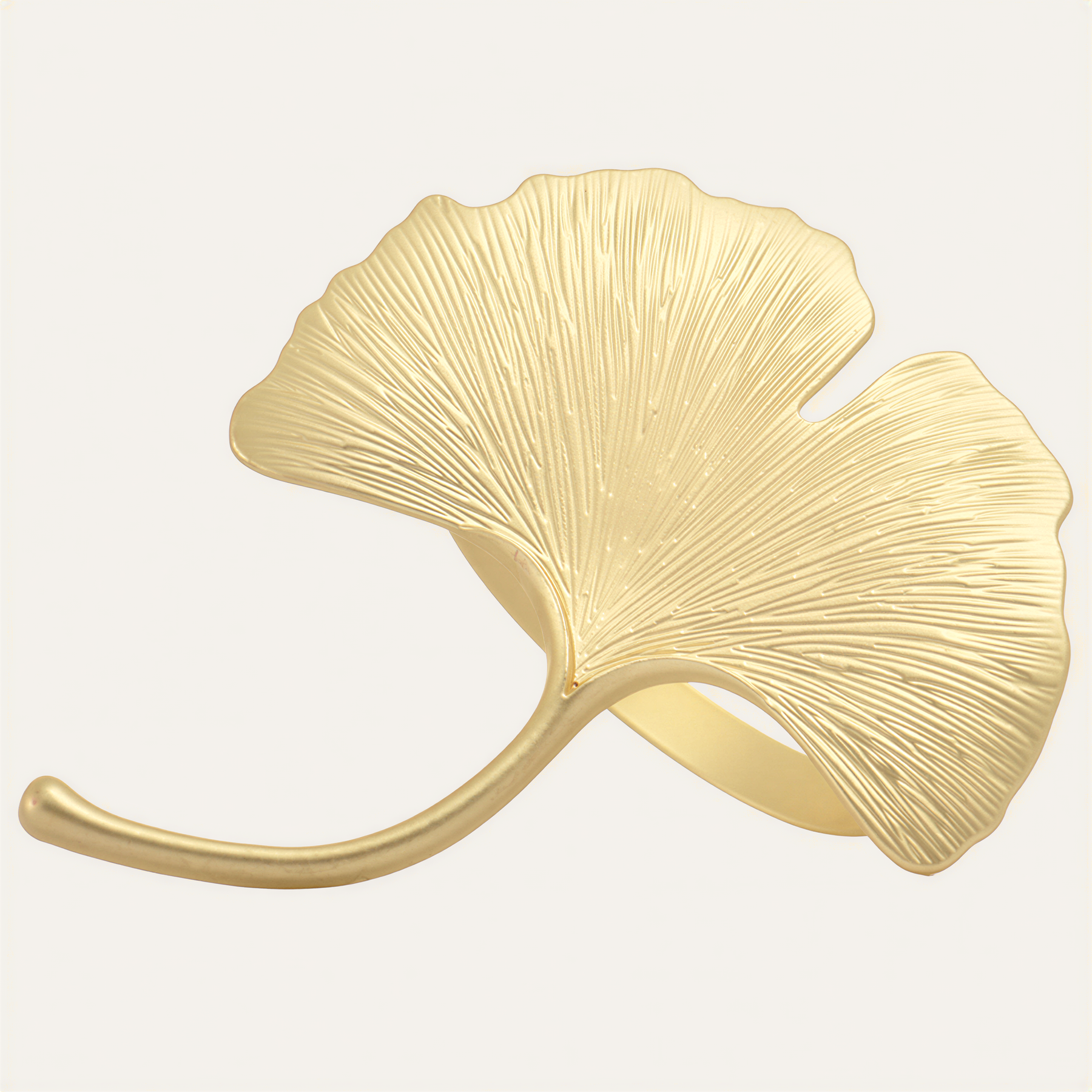 Set of four Auric Bloom napkin rings in gold leaf design, stylish decorative accents for dining tables.