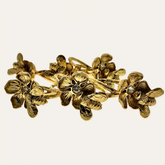 Set of four gold bee design napkin rings showcasing elegant, detailed jewelry-style accessories for table setting.