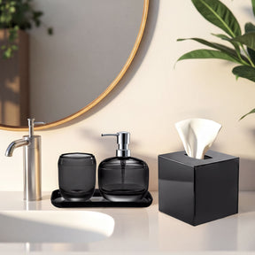 Set of four modern bathroom decor accessories from The Aurik Collection, featuring sleek and elegant design for stylish bathrooms.