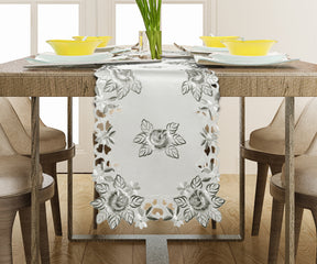 Linen table runner with intricate European embroidery, showcasing detailed craftsmanship on a stylish dining table.