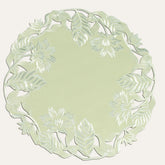 Set of four light green round linen doilies from The Daulton Collection, perfect for table decor and protect surfaces.