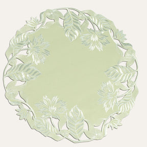 Set of four light green round linen doilies from The Daulton Collection, perfect for table decor and protect surfaces.