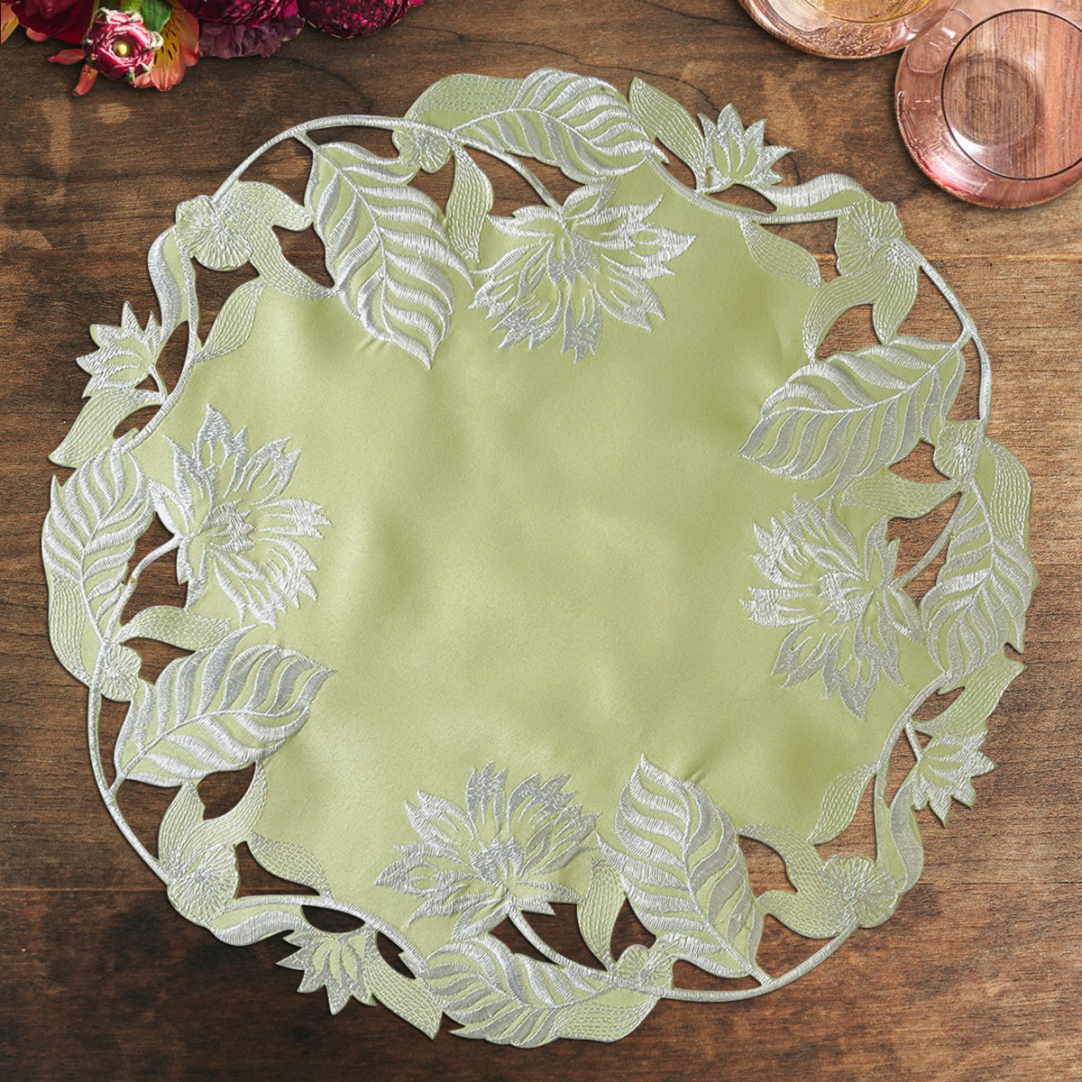 Set of four light green round linen doilies from The Daulton Collection, perfect for placemats and decorative table settings.