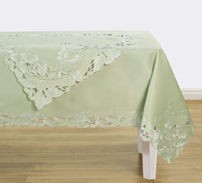 Set of four light green round linen placemat doilies from The Daulton Collection, showcasing elegant, textured linen fabric.