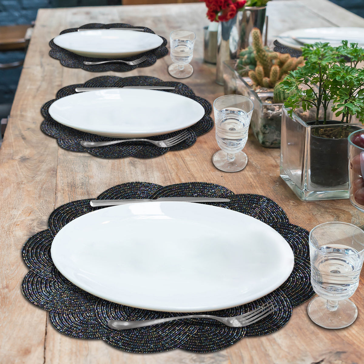 Embroidered beaded placemats from The Meribelle collection, featuring intricate beadwork for elegant table settings.
