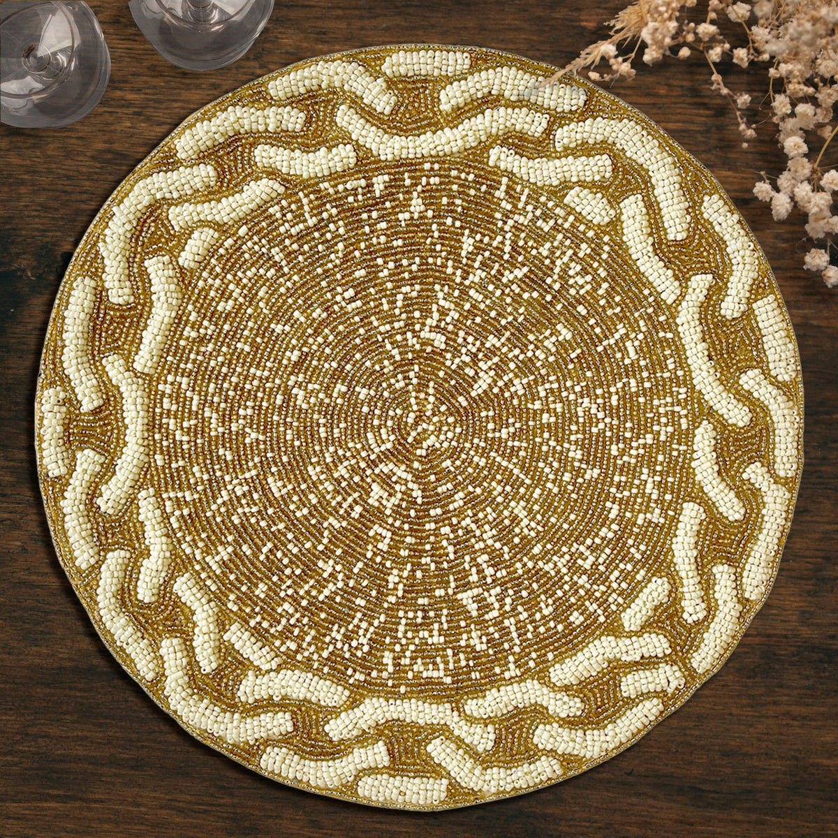Embroidered beaded placemat from The Floy collection, featuring intricate beadwork and decorative embroidery on a round surface.