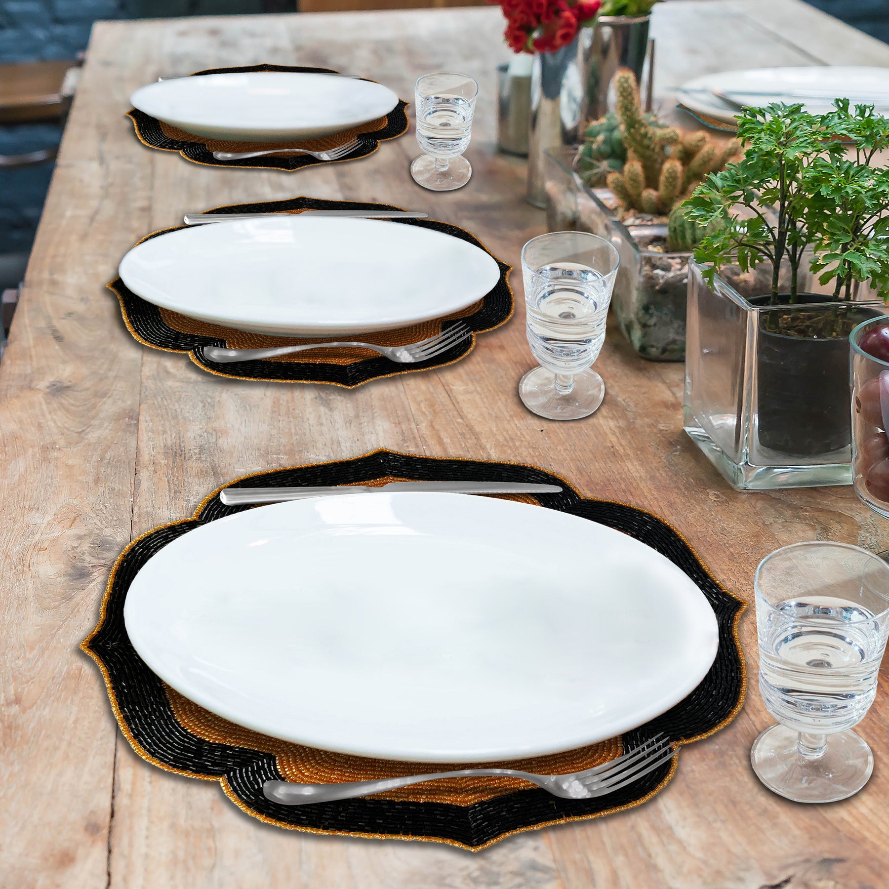 Set of two Amber Noir beaded placemats with embroidered design in warm copper and black, heat-resistant 14-inch table decor.