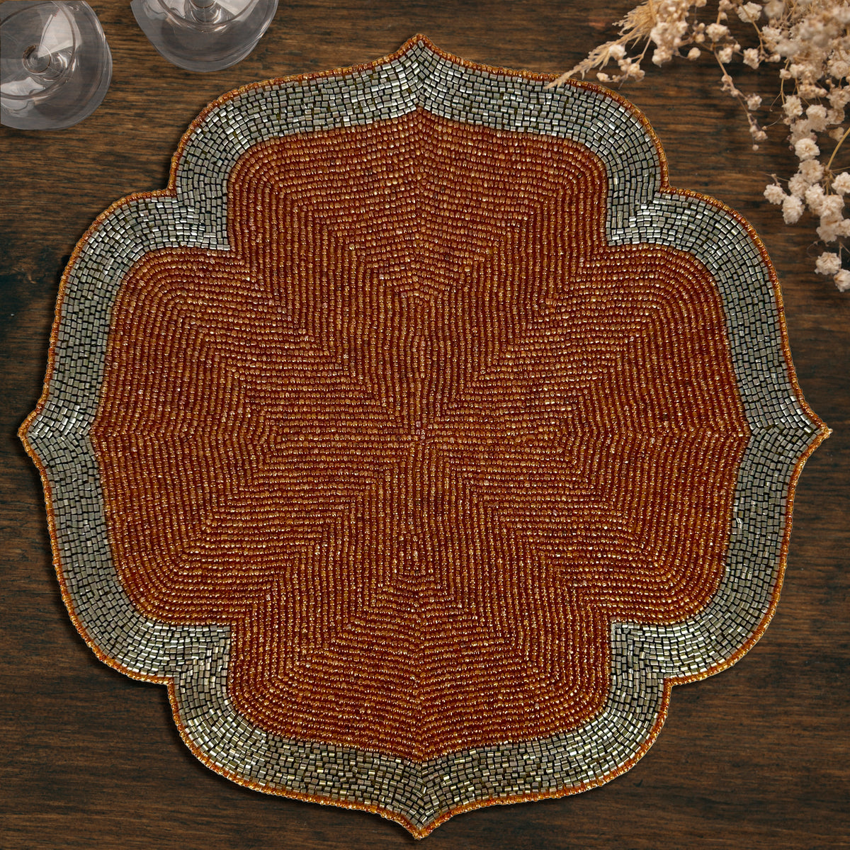 Set of two Sunset Frost beaded placemats in burnt orange and silver, embroidered decorative table accents, 14-inch diameter.