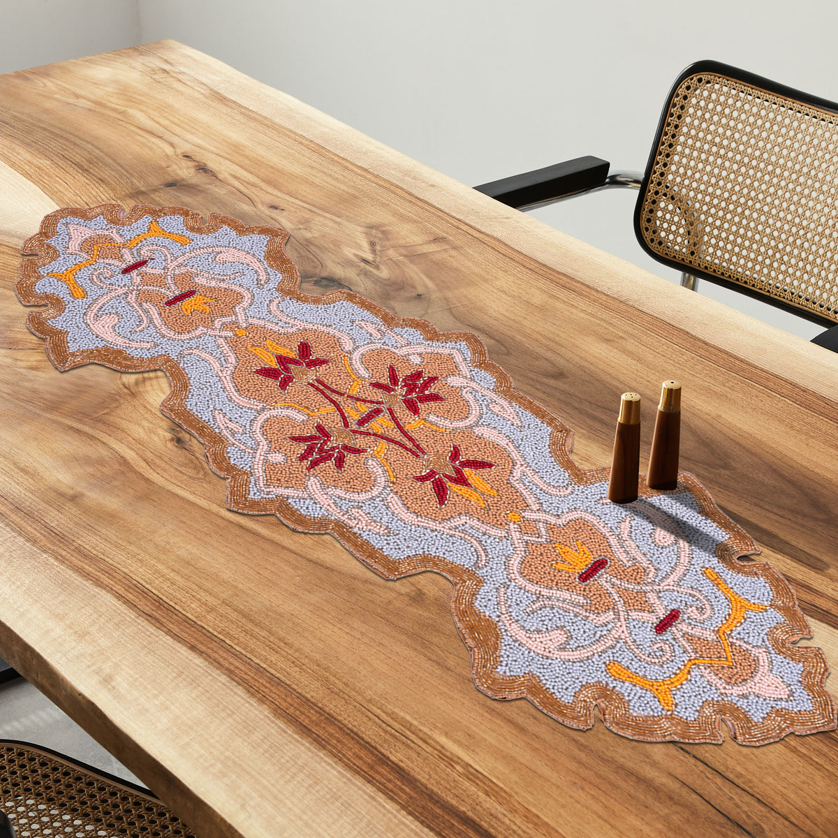 Beaded table runner by RNR 00009 featuring intricate beadwork and decorative design on a fabric table runner.