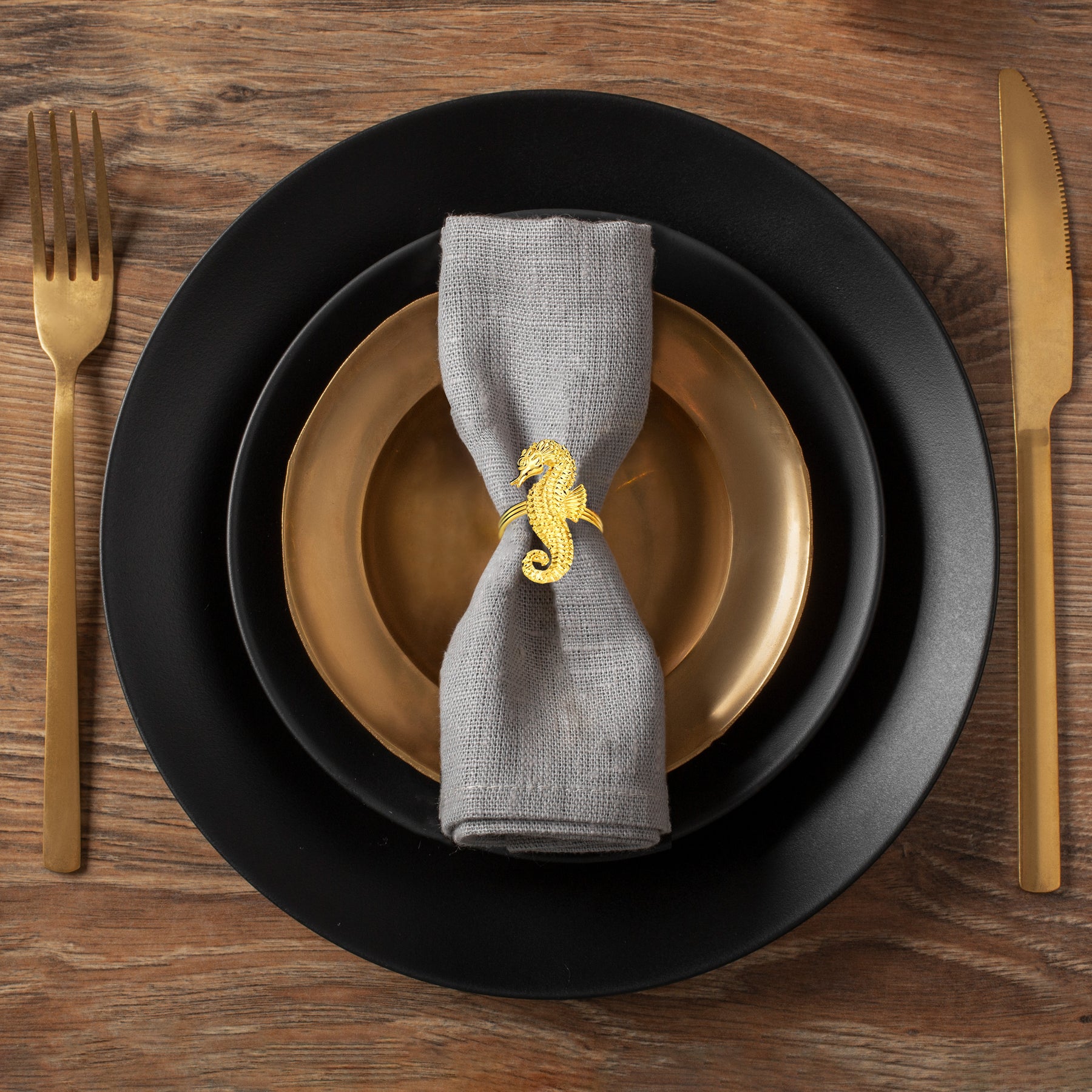 Set of four Ocean Majesty ZWZ-18-106-1 gold sea horse napkin rings, luxurious decorative dining table accents.