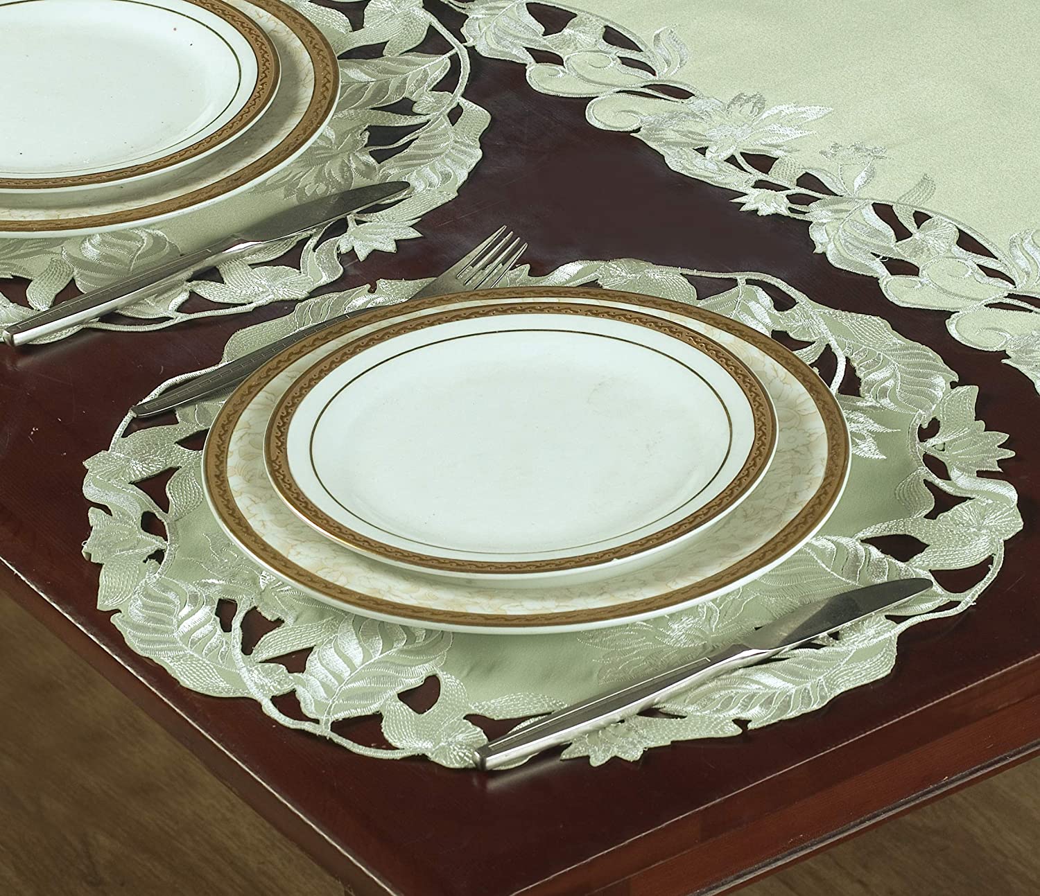 Set of four light green round linen placemat doilies from The Daulton Collection, perfect for table decor.