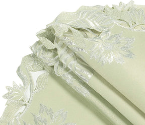 Set of four light green round linen doilies from The Daulton Collection, decorative placemats and doilies for table settings.