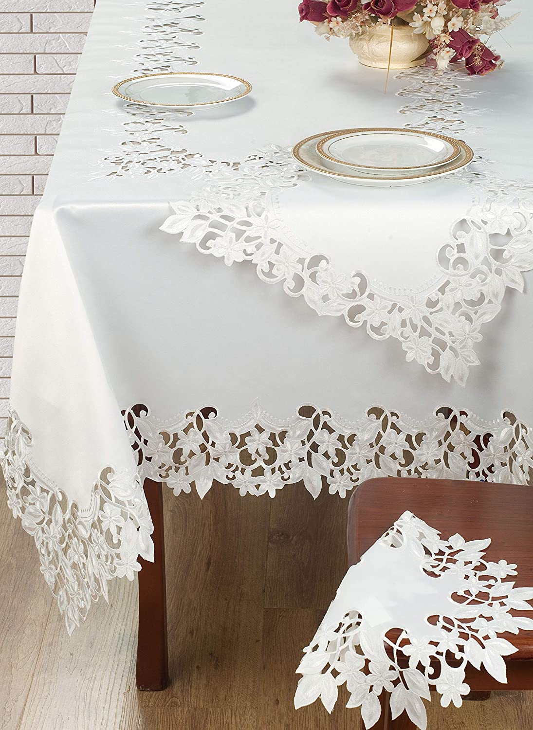 Linen table runner with intricate European embroidery from The Deandra Collection, showcasing detailed floral patterns.